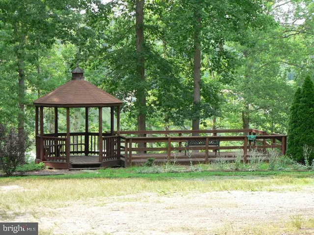 a view of a lake with lawn chairs and a slide