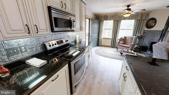 a kitchen with a stove a sink and a microwave