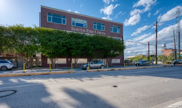 a view of a brick building next to a road
