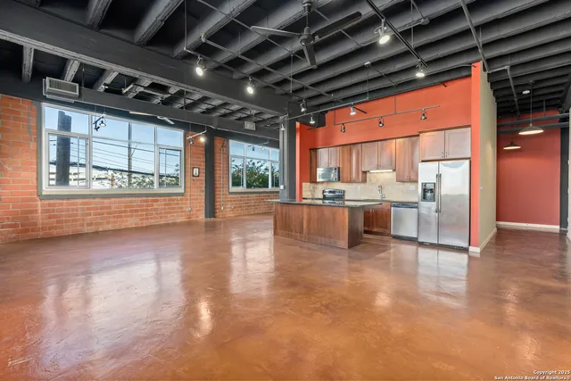 a view of a kitchen with a sink and cabinets