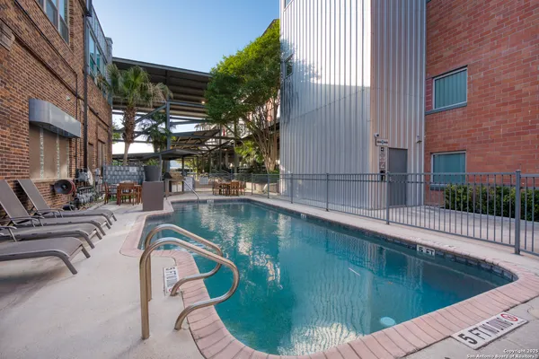 a view of swimming pool with outdoor seating