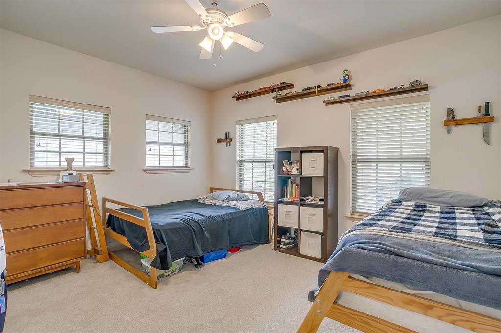 383 County Road 3672 Springtown, TX 76082 - Photo 16 of 39 1 of 2 guest bedroom with light carpet and a ceiling fan