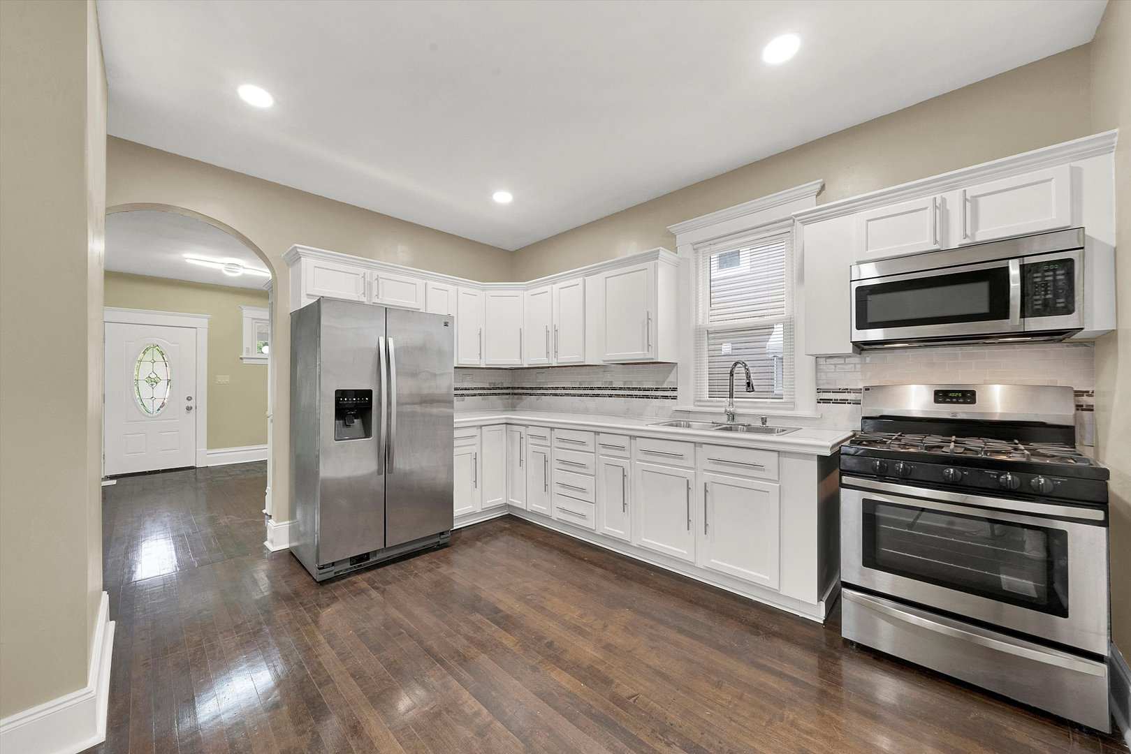 325 4th Street Waukegan, IL 60085 - Photo 13 of 34 a kitchen with granite countertop a refrigerator and a stove top oven