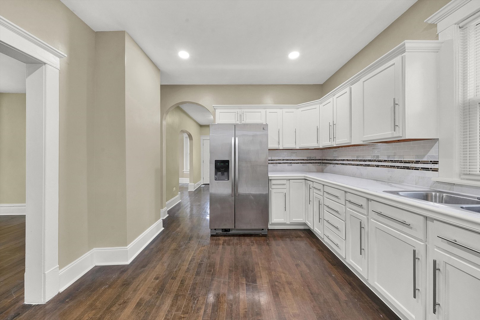 325 4th Street Waukegan, IL 60085 - Photo 14 of 34 a kitchen with cabinets oven and a wooden floor