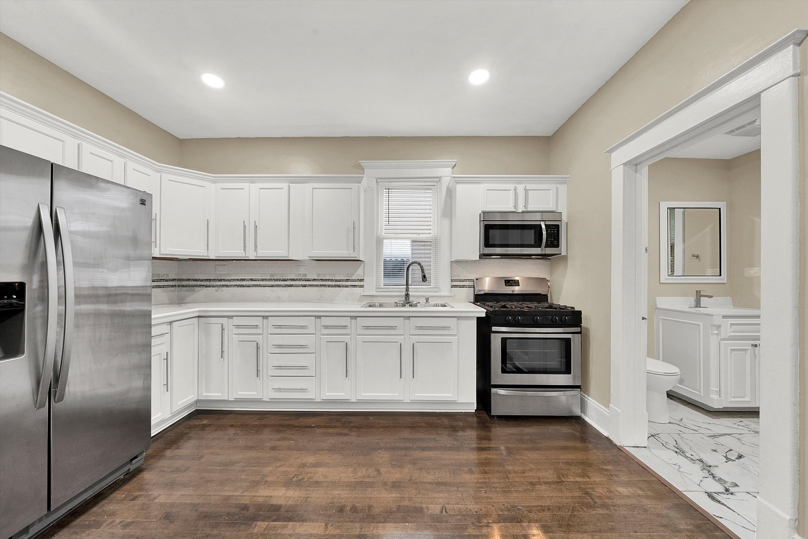 325 4th Street Waukegan, IL 60085 - Photo 16 of 34 a kitchen with granite countertop a refrigerator stove and microwave