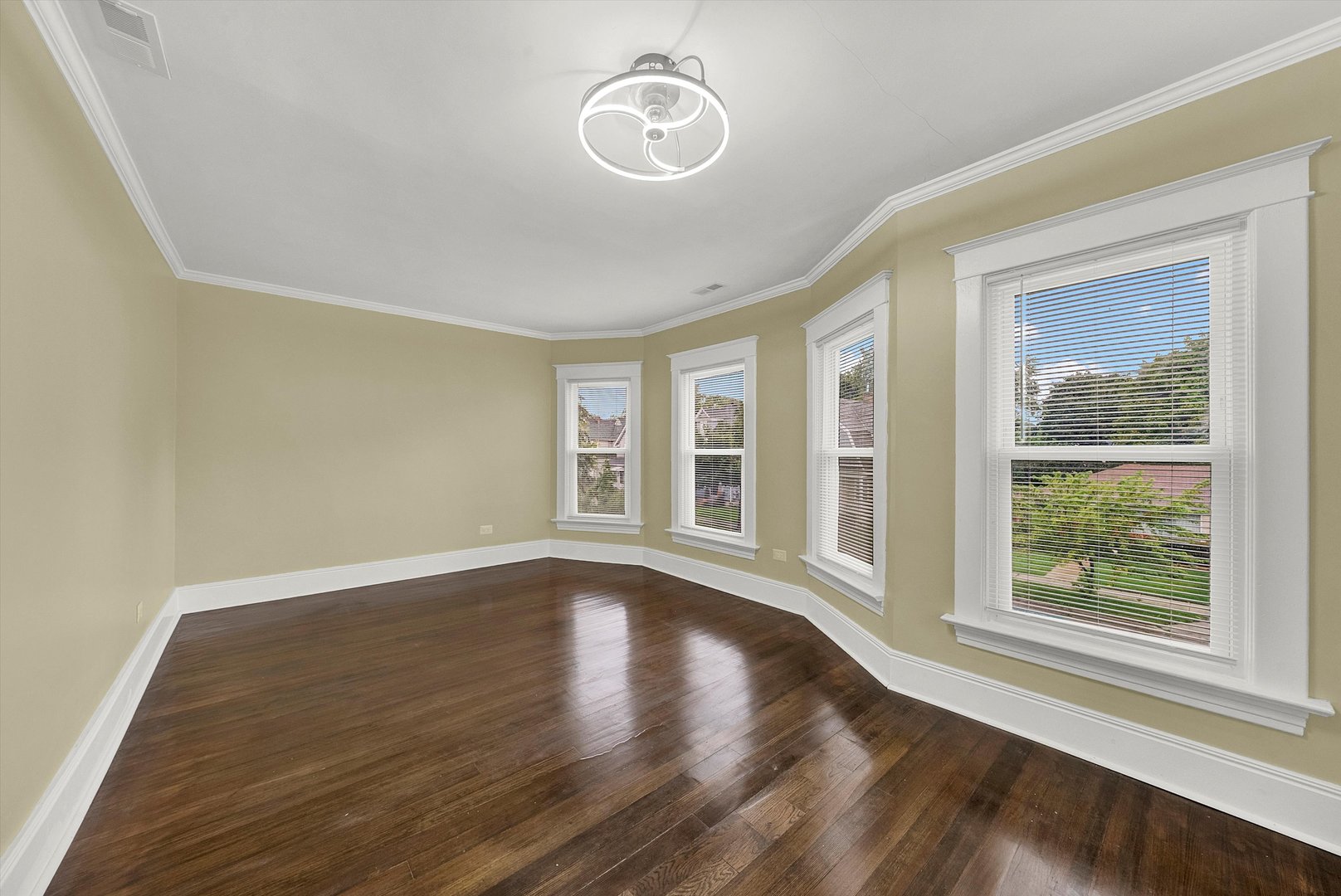325 4th Street Waukegan, IL 60085 - Photo 18 of 34 a view of an empty room with wooden floor and a window