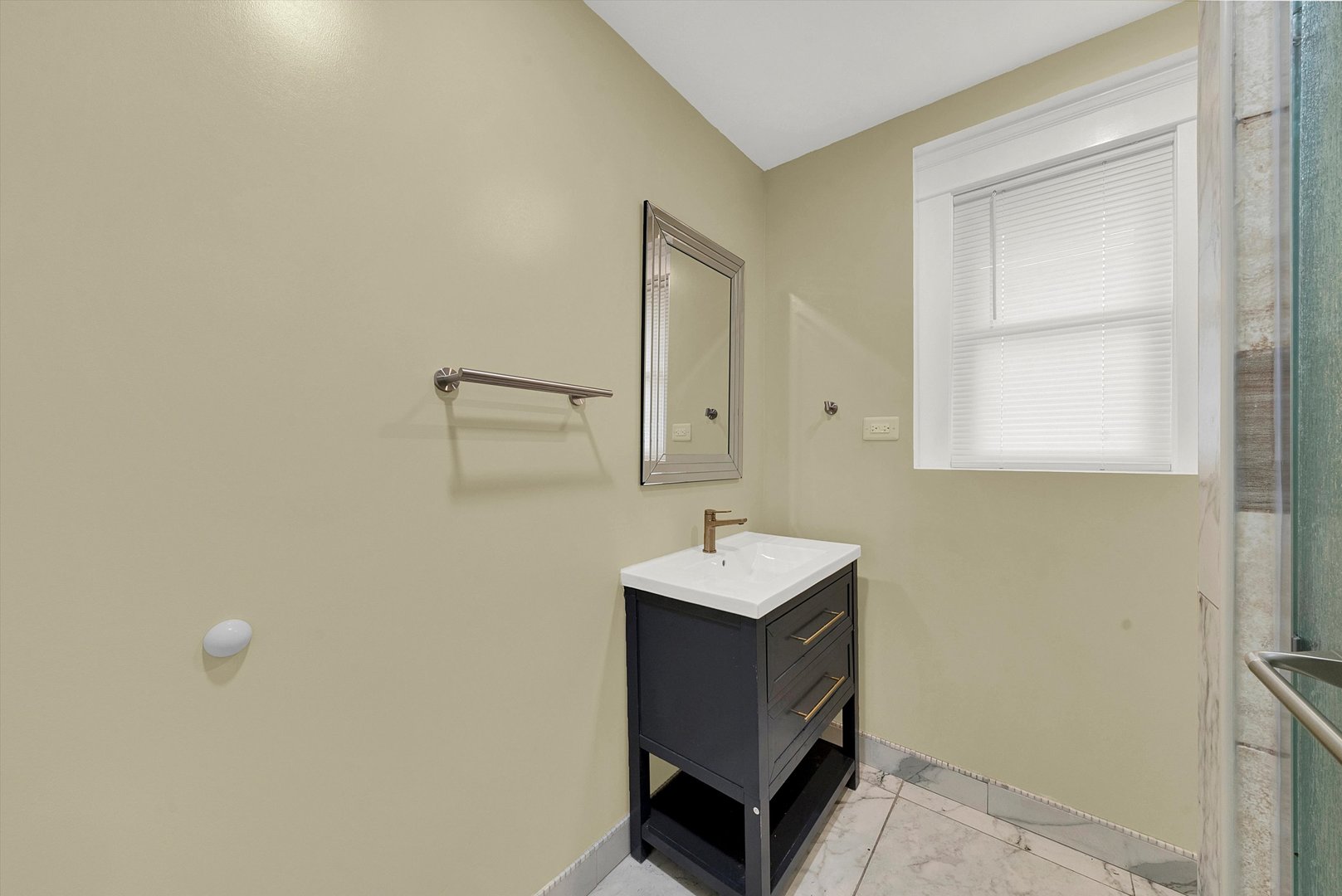 325 4th Street Waukegan, IL 60085 - Photo 22 of 34 a bathroom with a sink a mirror and a toilet