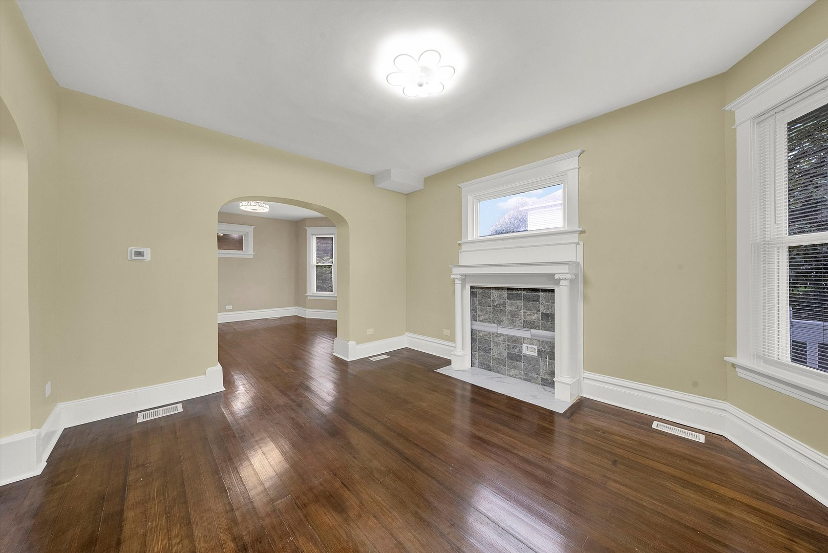 325 4th Street Waukegan, IL 60085 - Photo 3 of 34 a view of an empty room with wooden floor and a window
