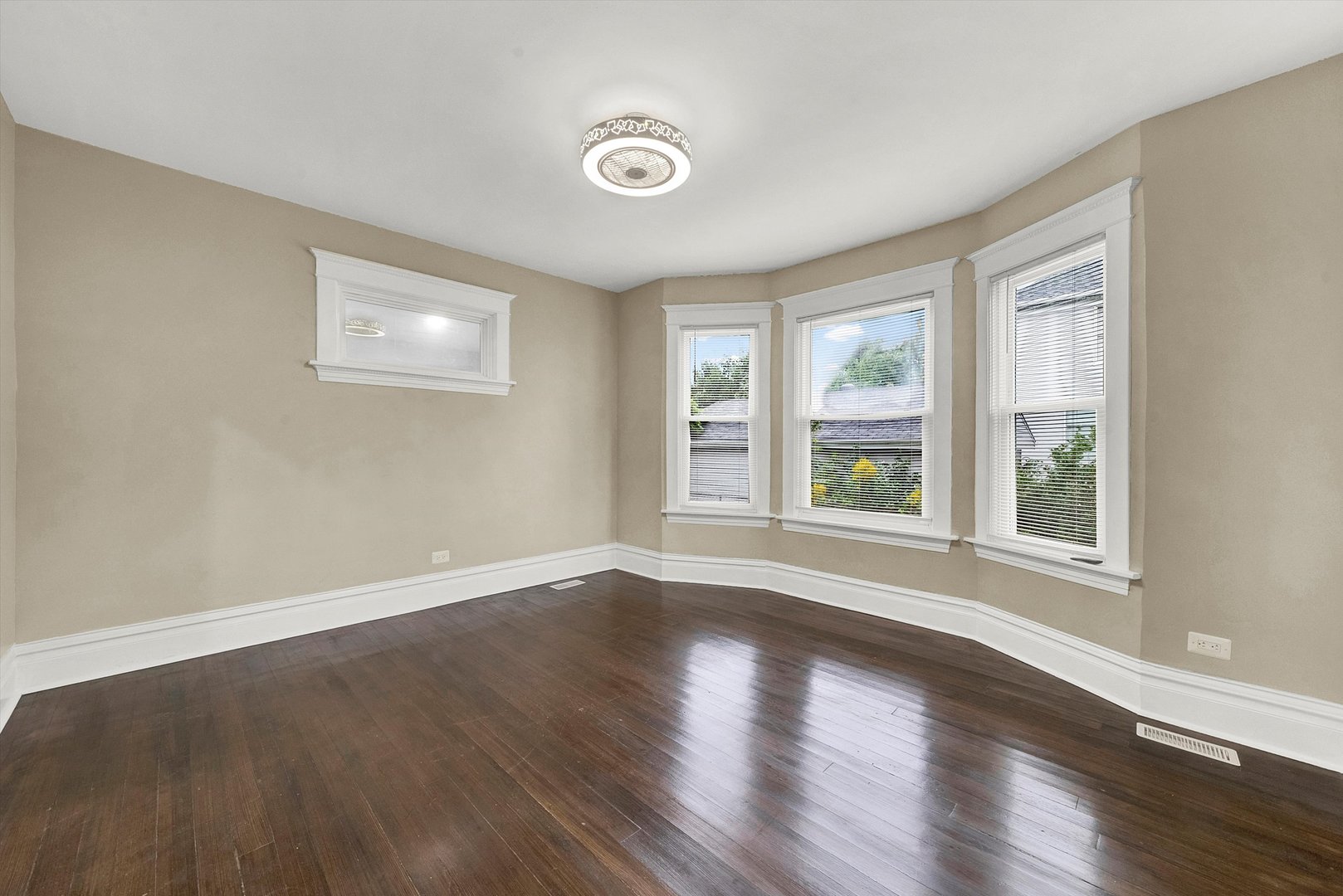 325 4th Street Waukegan, IL 60085 - Photo 9 of 34 a view of an empty room with wooden floor and a window