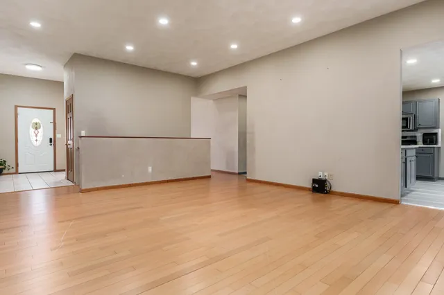 a view of an empty room with wooden floor