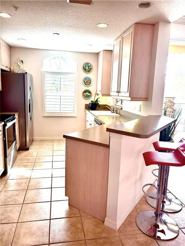 a bedroom with a bed a lamp and paintings on the wall