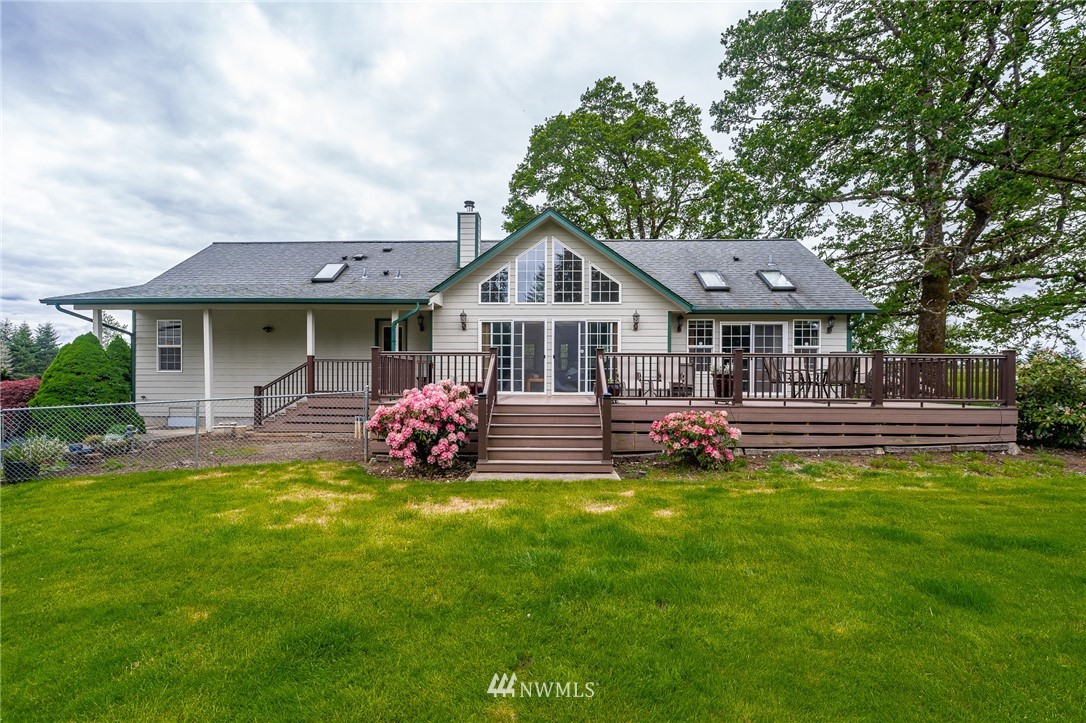 249 South Military Road Winlock, WA 98596 - Photo 1 of 33 a front view of a house with a garden and trees