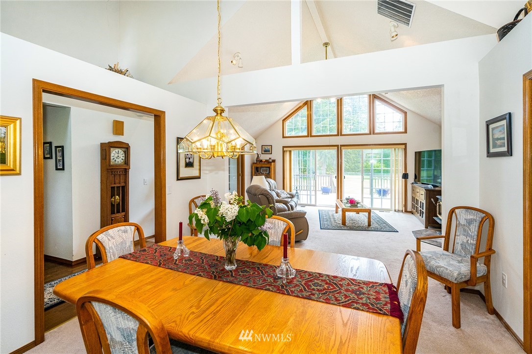 249 South Military Road Winlock, WA 98596 - Photo 11 of 33 a view of a dining room with furniture a chandelier and large windows