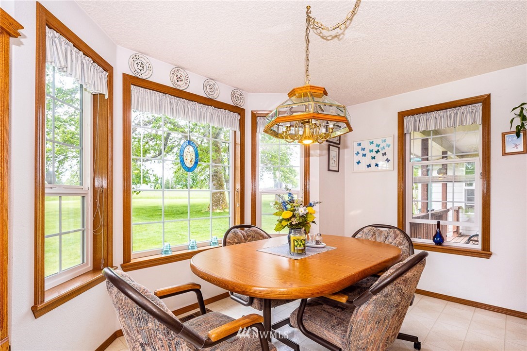 249 South Military Road Winlock, WA 98596 - Photo 12 of 33 a dining room with furniture a chandelier and wooden floor