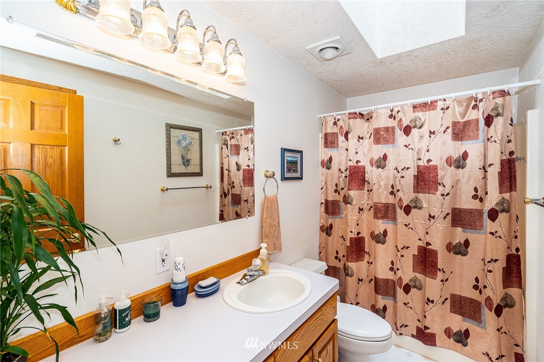 249 South Military Road Winlock, WA 98596 - Photo 15 of 33 a bathroom with a sink toilet and shower