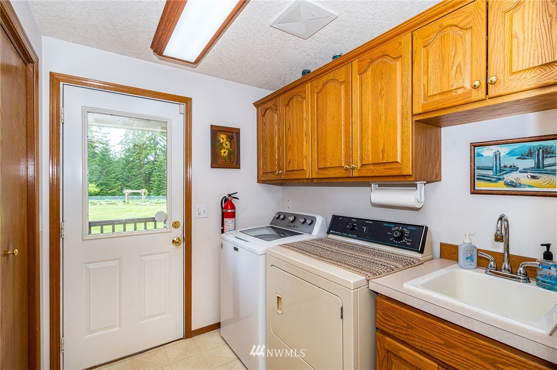 249 South Military Road Winlock, WA 98596 - Photo 16 of 33 a utility room with sink dryer and washer