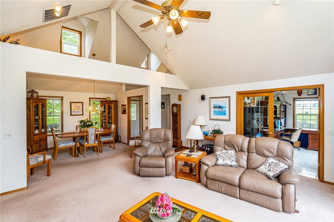 249 South Military Road Winlock, WA 98596 - Photo 5 of 33 a living room with furniture ceiling fan and a large window