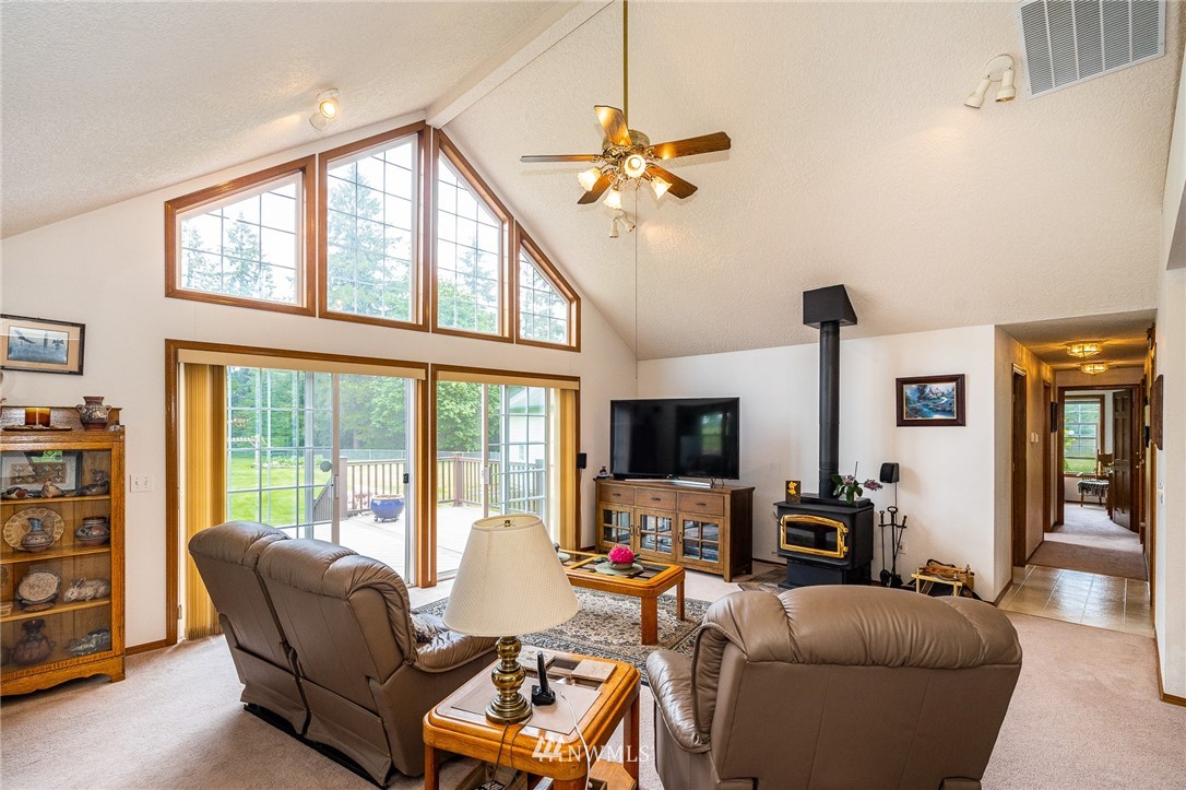 249 South Military Road Winlock, WA 98596 - Photo 6 of 33 a living room with furniture a flat screen tv and a large window