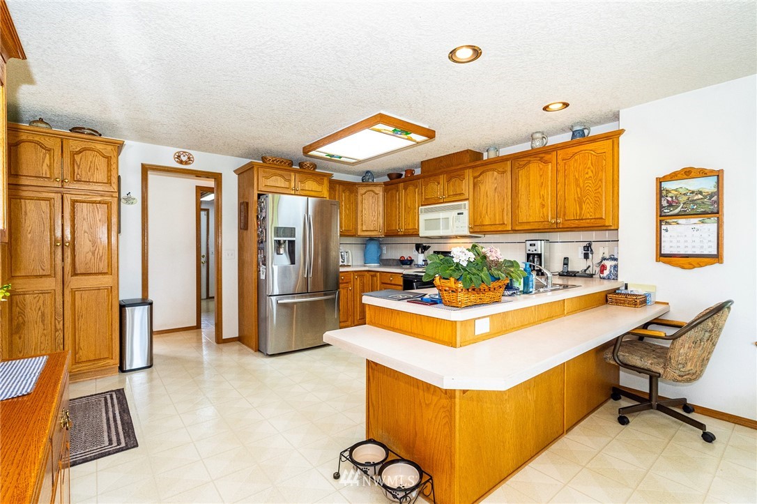249 South Military Road Winlock, WA 98596 - Photo 8 of 33 a large living room with stainless steel appliances kitchen island granite countertop furniture and a chandelier