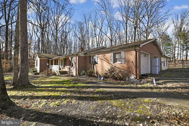 a view of a house with a yard and a fountain