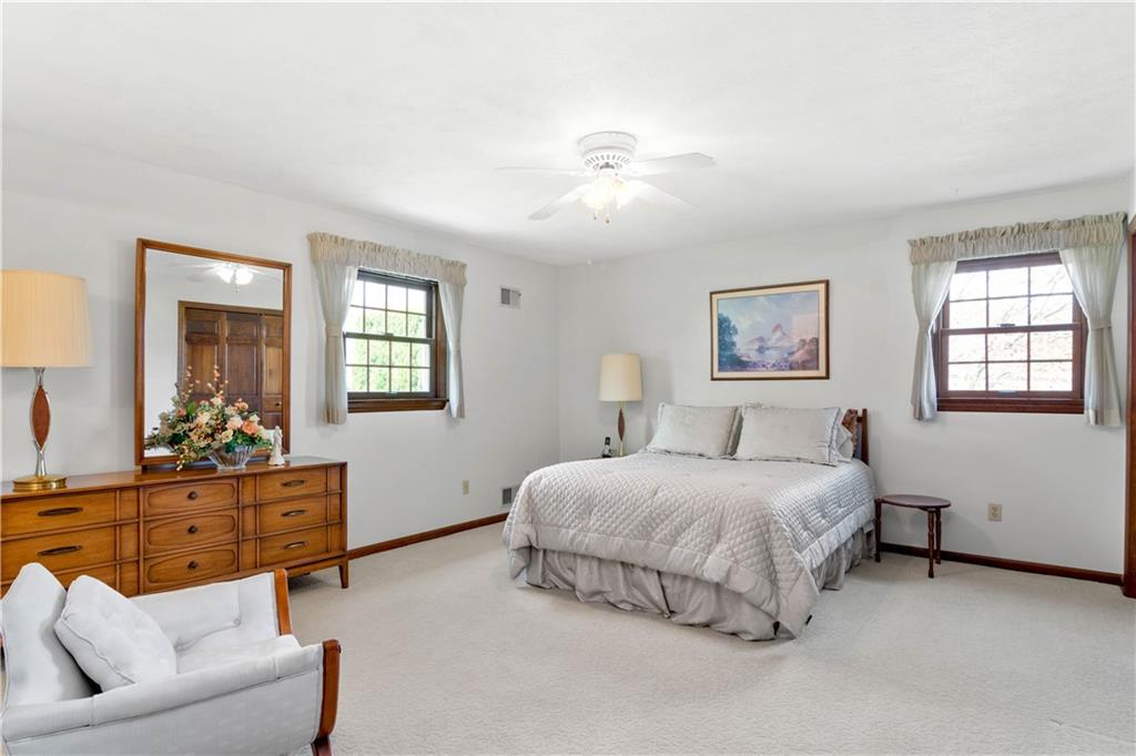 313 Knobs Hill Court Wexford, PA 15090 - Photo 13 of 25 a bedroom with a bed and ceiling fan