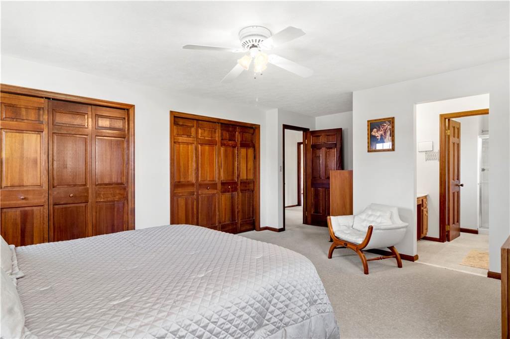 313 Knobs Hill Court Wexford, PA 15090 - Photo 14 of 25 a bedroom with a bed and a chandelier