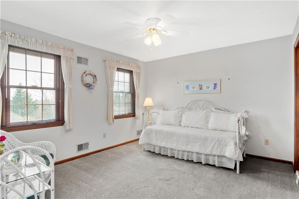 313 Knobs Hill Court Wexford, PA 15090 - Photo 16 of 25 a bedroom with a bed and a chandelier