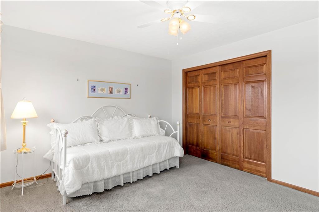 313 Knobs Hill Court Wexford, PA 15090 - Photo 17 of 25 a spacious bedroom with a bed and a chandelier