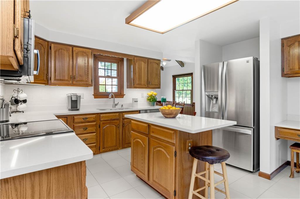 313 Knobs Hill Court Wexford, PA 15090 - Photo 7 of 25 a kitchen with a sink a stove and refrigerator