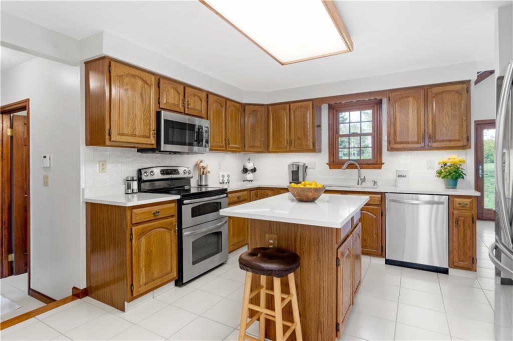 313 Knobs Hill Court Wexford, PA 15090 - Photo 8 of 25 a kitchen with a sink stove and microwave