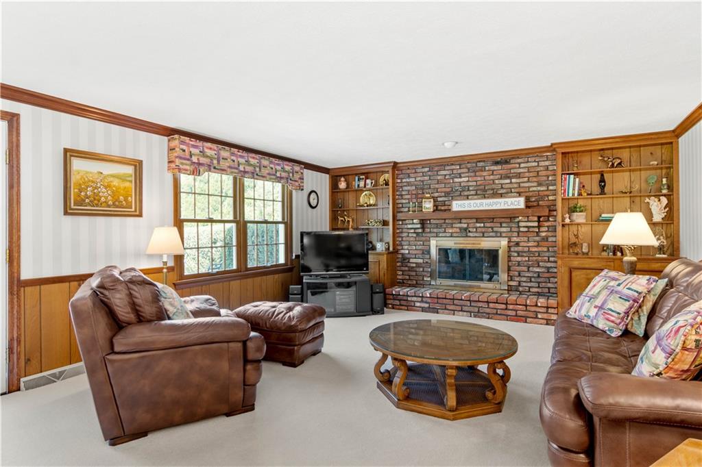 313 Knobs Hill Court Wexford, PA 15090 - Photo 10 of 25 a living room with furniture a fireplace and a flat screen tv