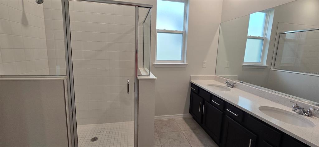 7193 Southwest 64th St Road Ocala, FL 34474 - Photo 13 of 17 a bathroom with a double vanity sink and a mirror