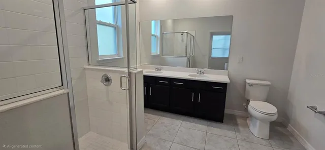 a bathroom with a granite countertop toilet sink and mirror