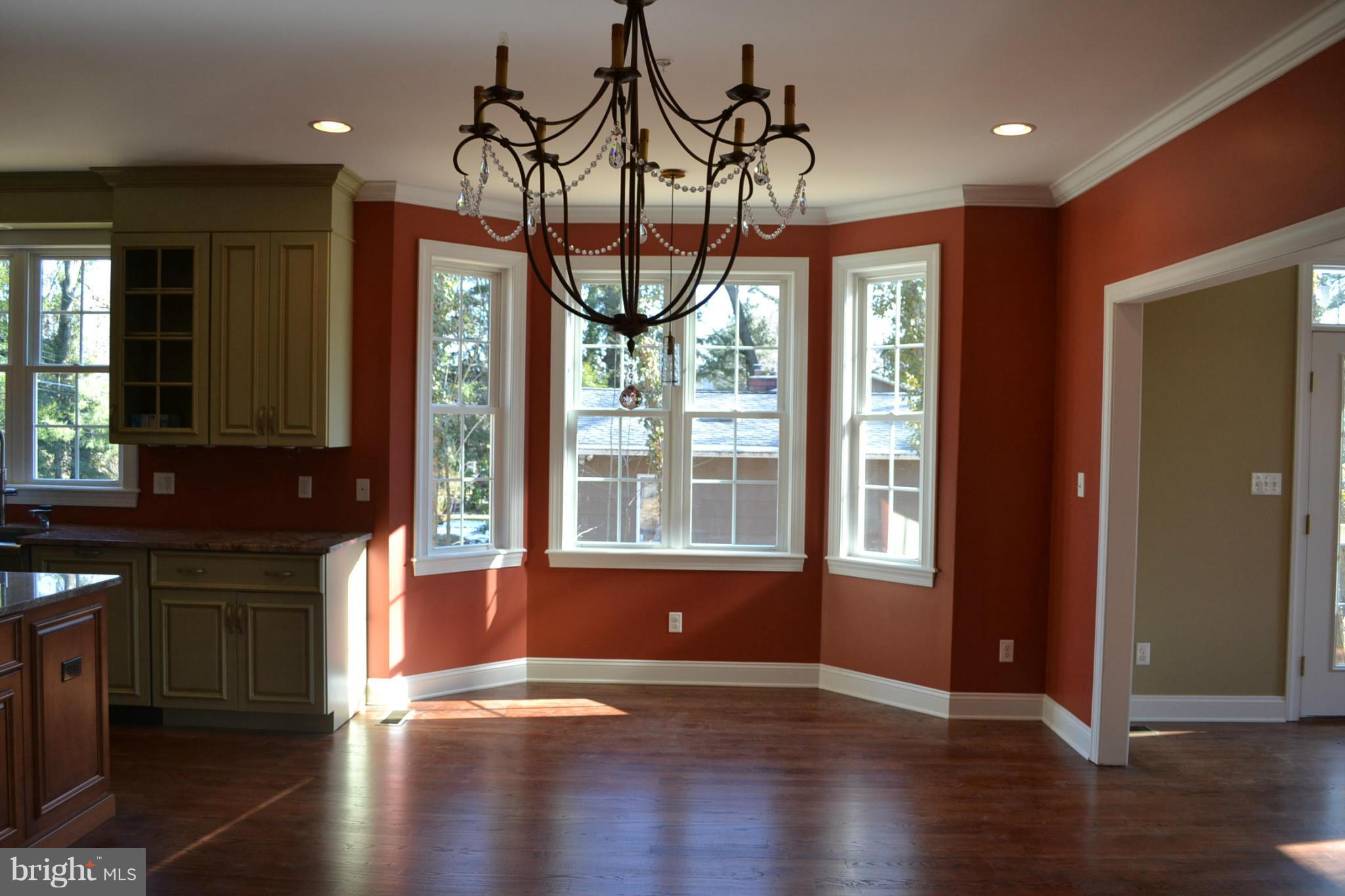 2405 Steele Road Baltimore, MD 21209 - Photo 3 of 11 an empty room with wooden floor and windows