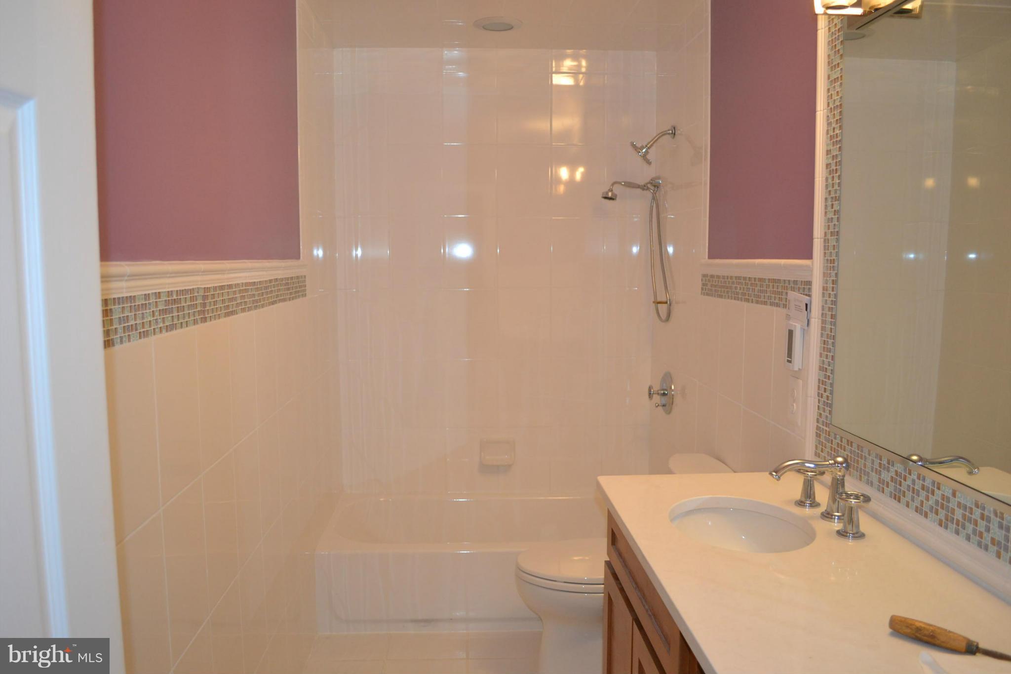 2405 Steele Road Baltimore, MD 21209 - Photo 8 of 11 a bathroom with a sink a toilet and shower