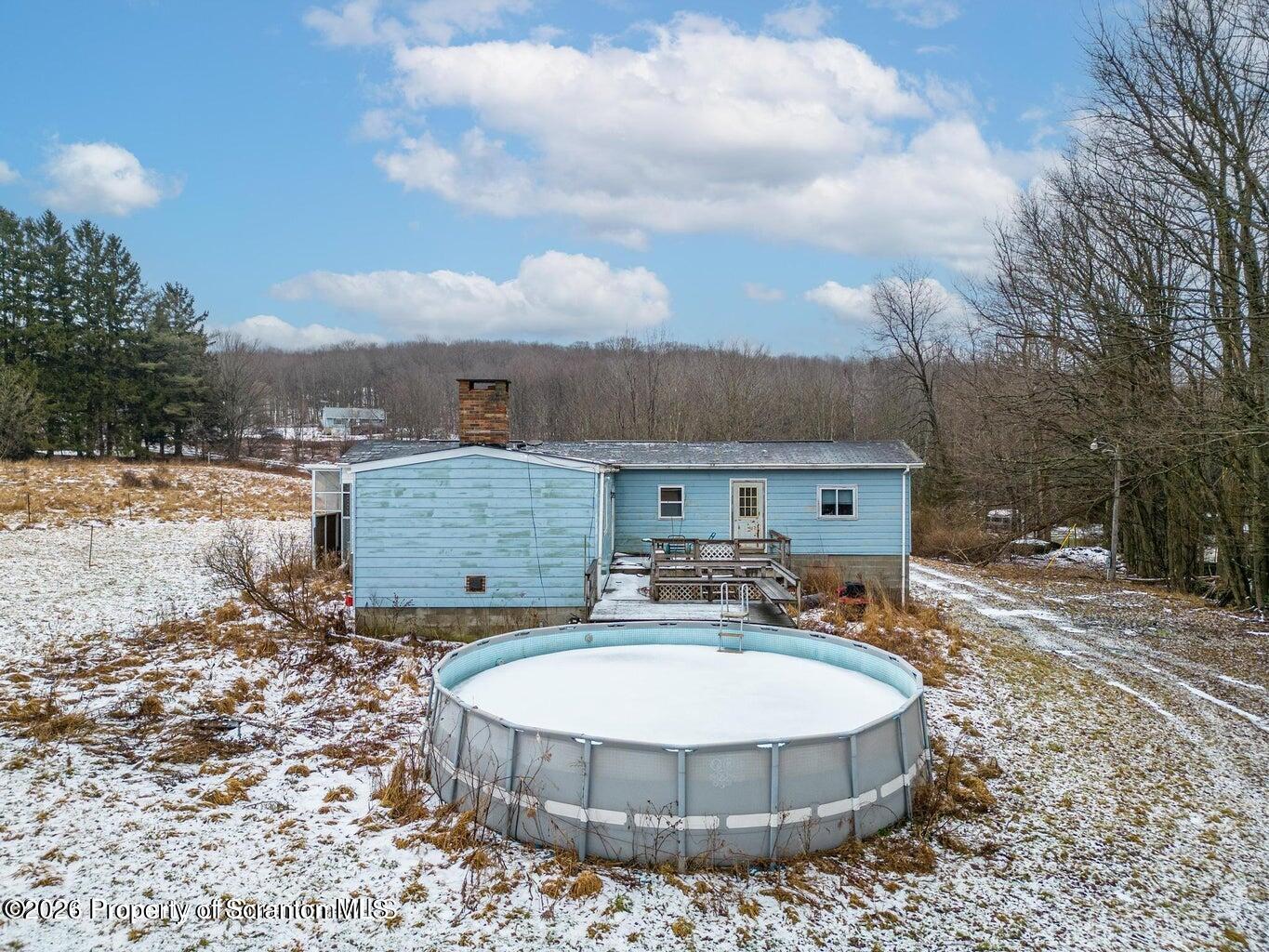 1777 Lamb Road Thompson, PA 18465 - Photo 1 of 31 a roof view covered with sky view