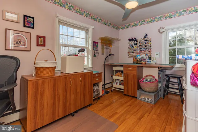 a living room with furniture a piano and wooden floor