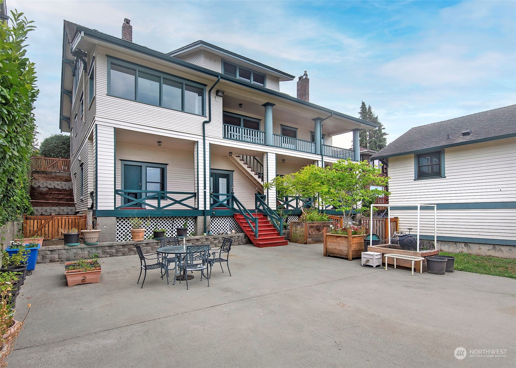 2208 Rucker Avenue Everett, WA 98201 - Photo 1 of 29 a view of the patio with dining table and chairs and potted plants