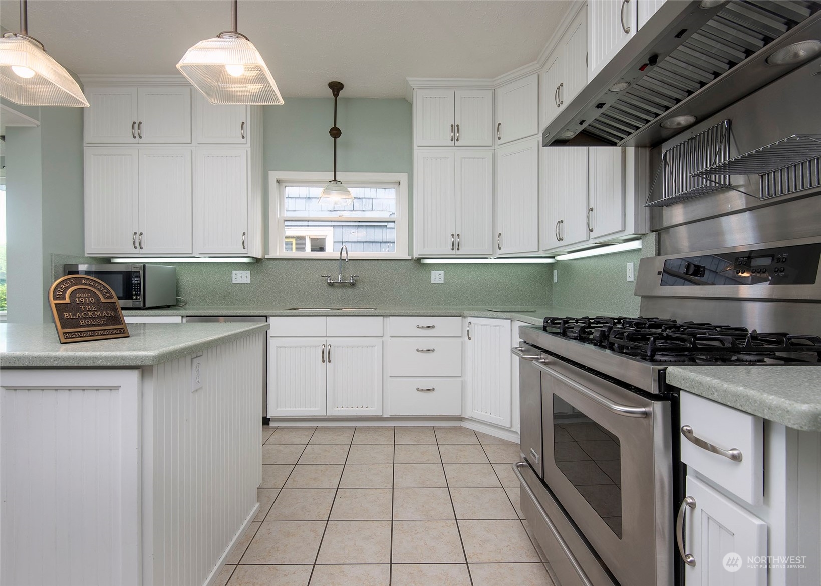 2208 Rucker Avenue Everett, WA 98201 - Photo 23 of 29 a kitchen with cabinets appliances and a window
