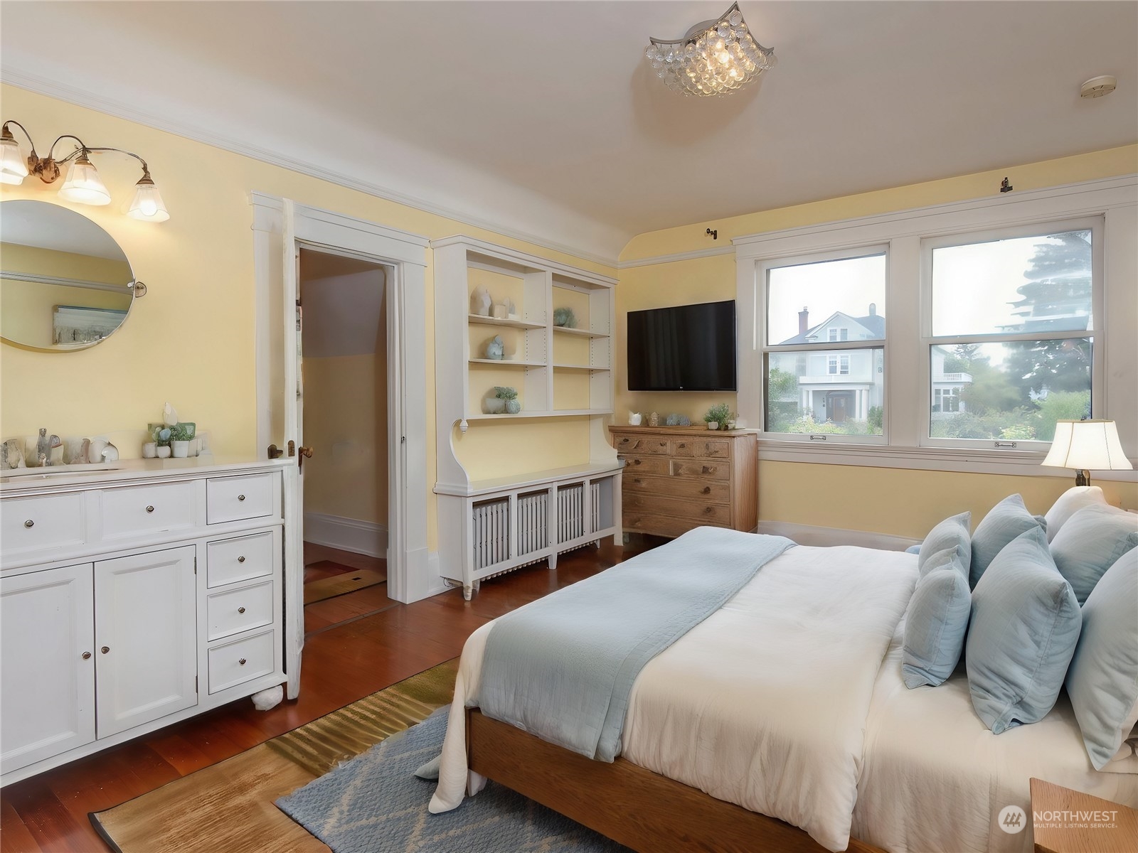 2208 Rucker Avenue Everett, WA 98201 - Photo 10 of 29 a bedroom with a bed and a flat tv screen on dresser