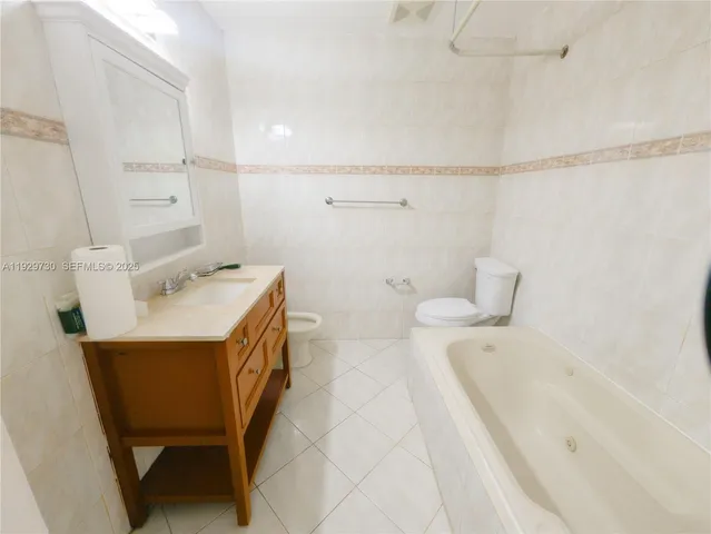 a bathroom with a sink a mirror and a bathtub