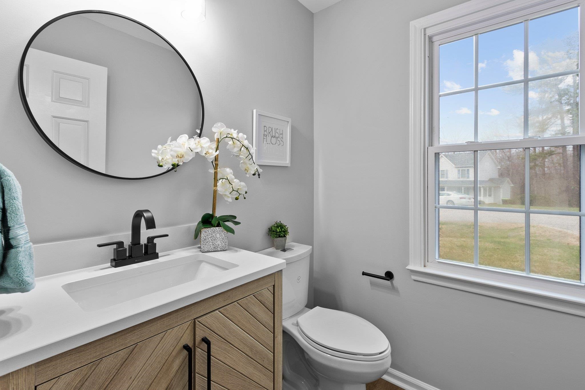 5616 Torness Court Raleigh, NC 27604 - Photo 15 of 37 Beautiful main floor half bath with updated vanity and window for natural light. Half Bathroom