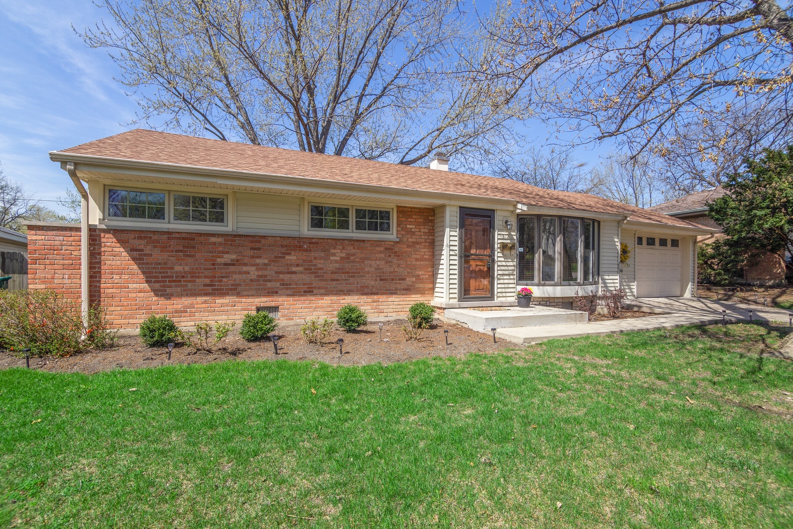 812 Meadow Road Northbrook, IL 60062 - Photo 1 of 10 a front view of a house with patio and garden