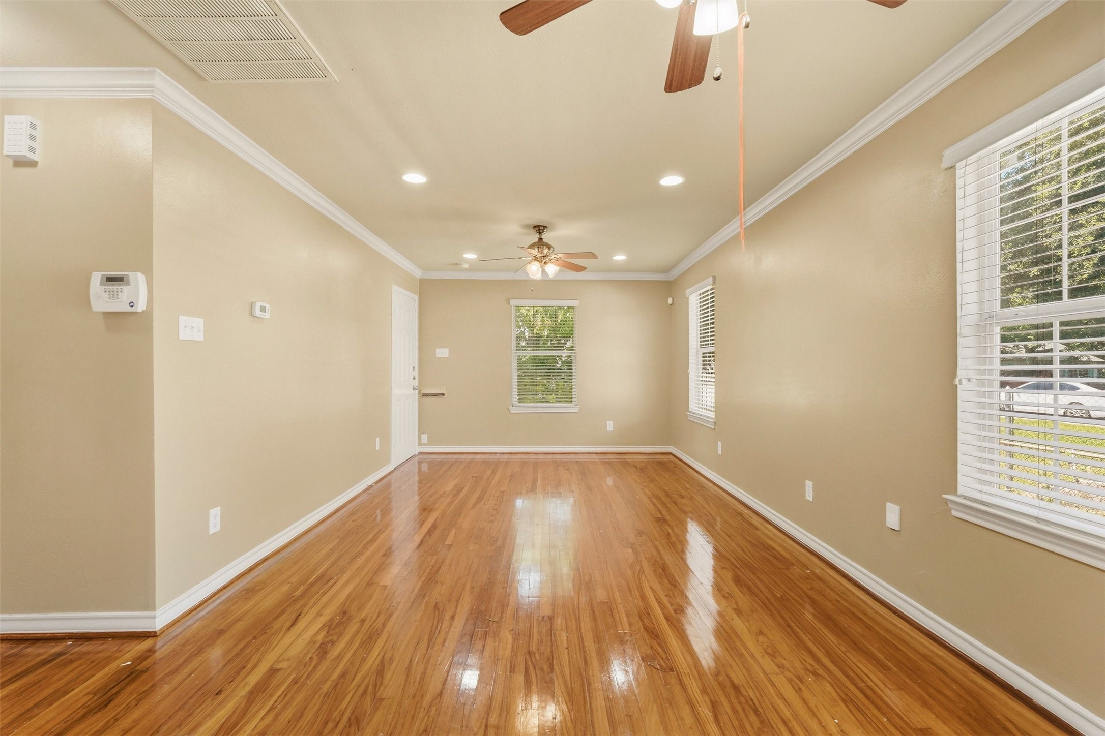 3445 Nathaniel Brown Street Houston, TX 77021 - Photo 6 of 19 a view of an empty room with wooden floor and a window