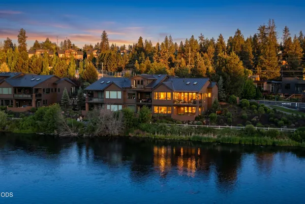 a view of a house with a yard and a pond