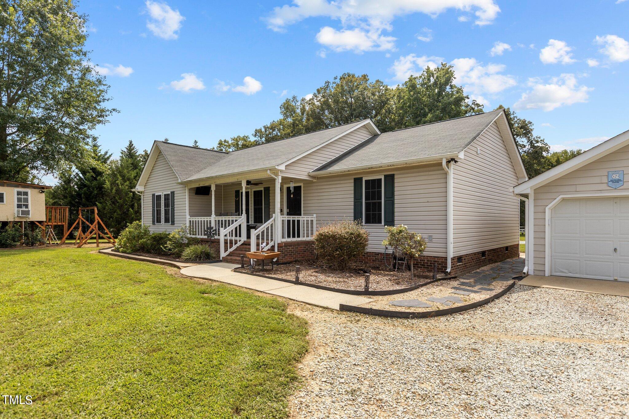 810 Willie Gray Road Timberlake, NC 27583 - Photo 2 of 28 a view of a house with backyard and sitting area