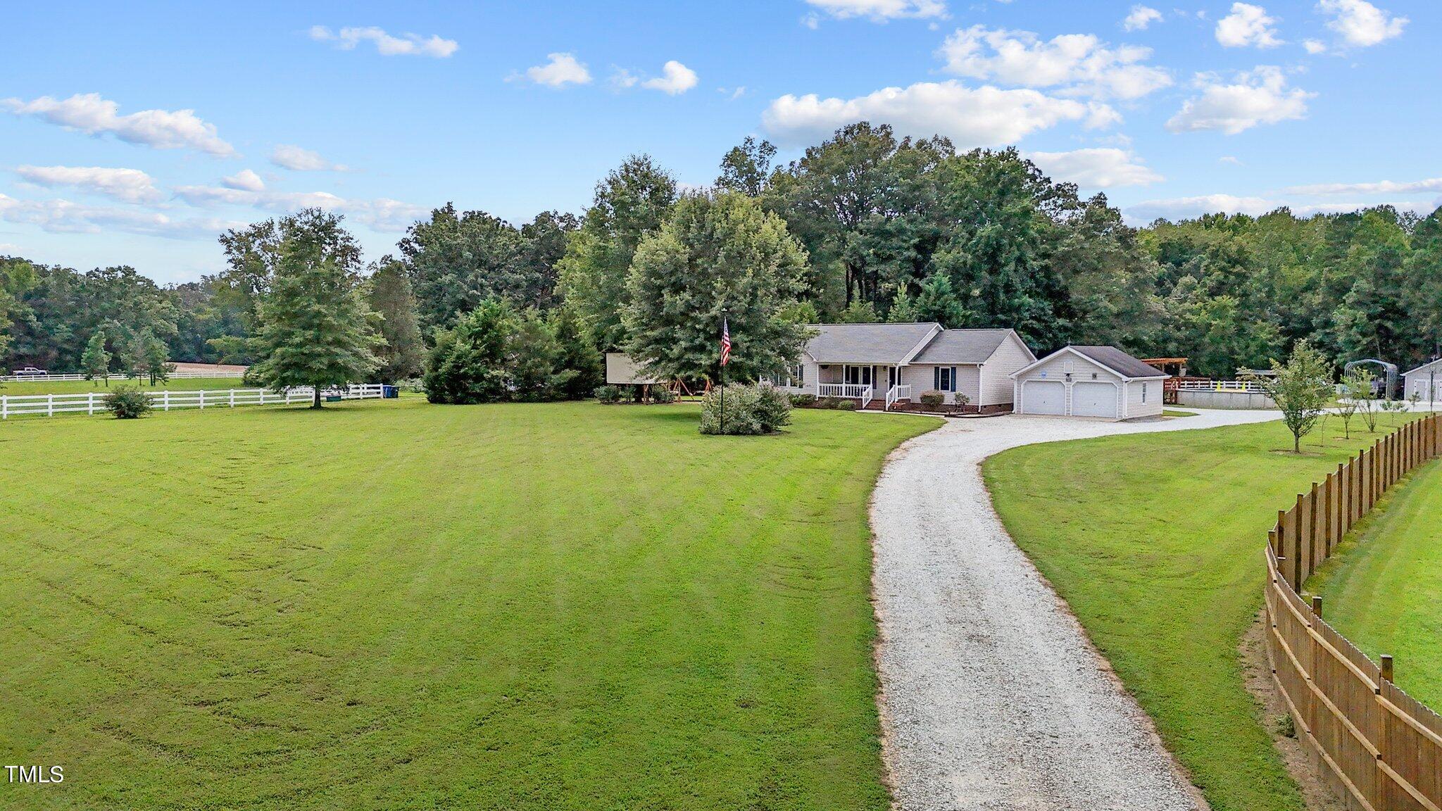 810 Willie Gray Road Timberlake, NC 27583 - Photo 4 of 28 a view of a lake with a building in the background