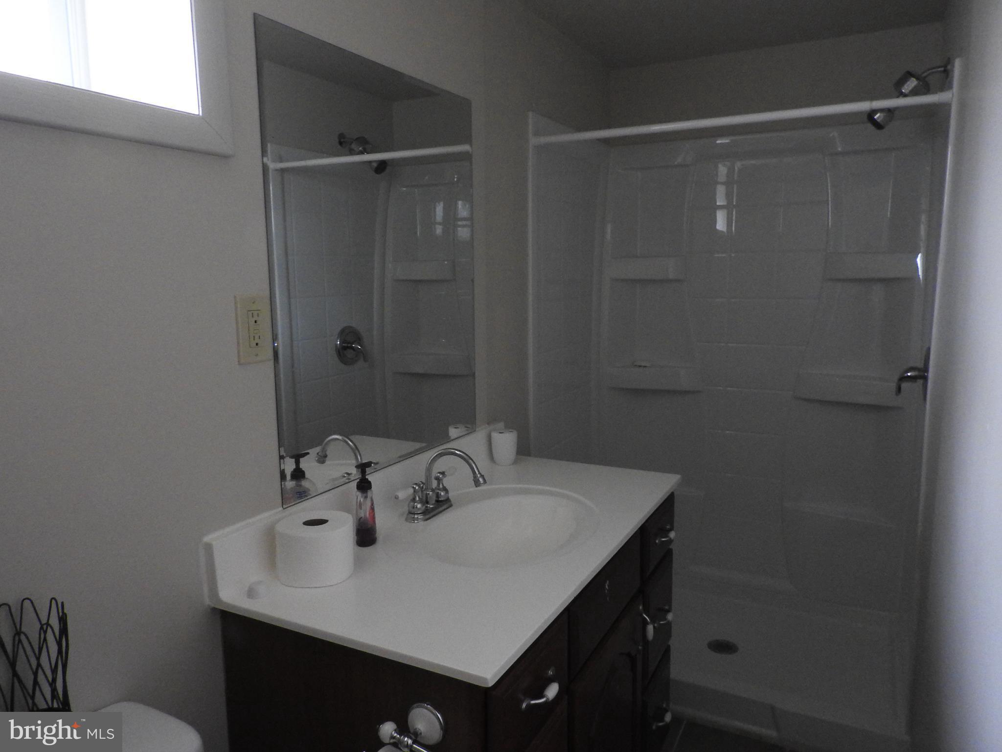 2711 Bel Pre Road Silver Spring, MD 20906 - Photo 16 of 19 a bathroom with a sink vanity and a mirror