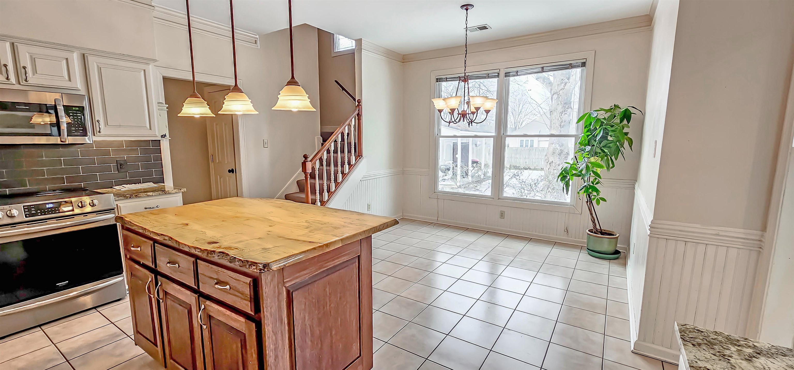 660 Weston Drive Collierville, TN 38017 - Photo 9 of 32 a kitchen with a stove a sink a counter top space and cabinets