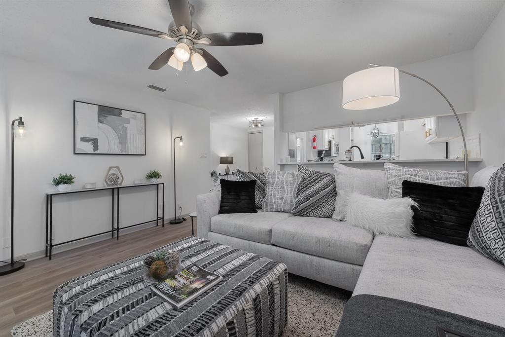 5981 Arapaho Road, Unit 305 Dallas, TX 75248 - Photo 1 of 39 a living room with furniture and a chandelier